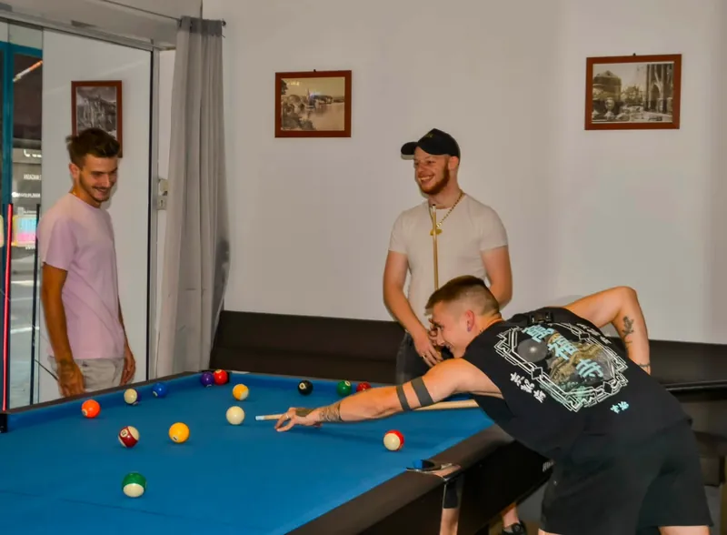 Trois amis autour d'une table de billard